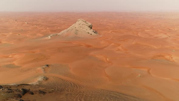 Aerial view of mountain in the middle of desert during sunset, U.A.E