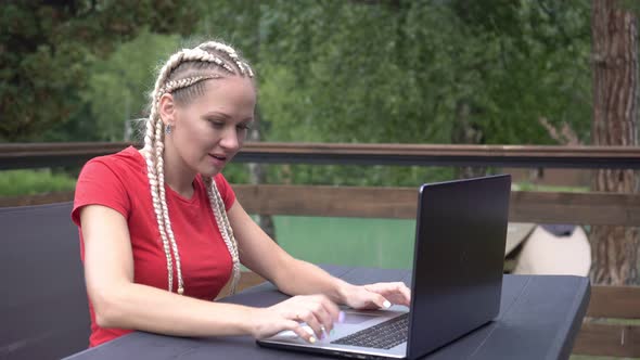 Woman with Laptop Emotionally Rejoices at Success