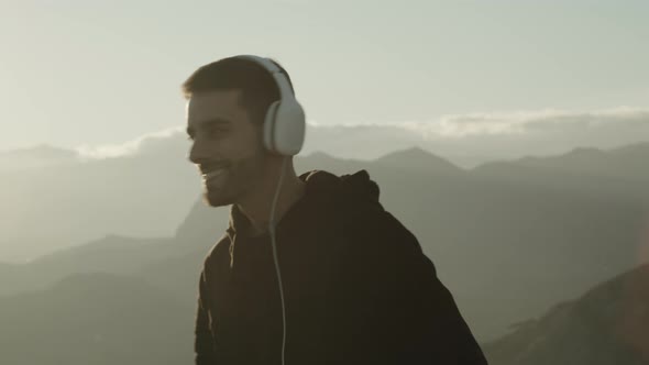 Guy Walks Listening Music At Sunset with headphones  with music