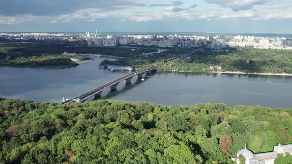 Aerial View of the City Skyline with a Bridge Over the River and Green Nature