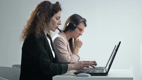 Call Center Operators Wearing Headphones