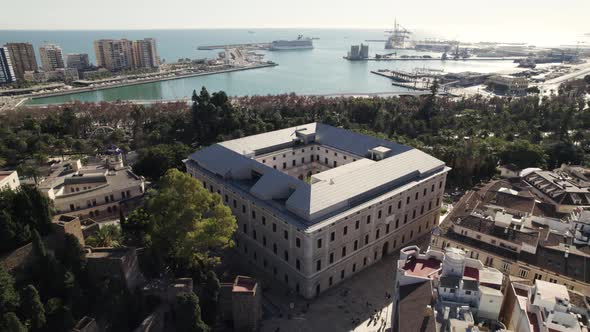 Royal Academy of Fine Arts of San Telmo and Malaga Museum with port in background, Spain. Aerial cir