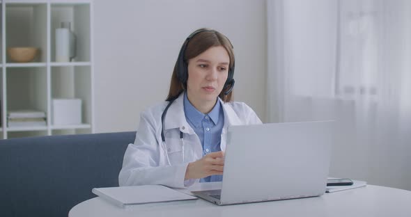 Consultation of Doctor By Telephone, Female Physician Is Answering on Questions of Patients in Call