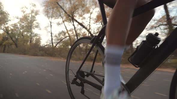 Gear System And Bike Wheel Rotation. Cyclist Twists Pedals And Riding On Bicycle. Sport Concept.