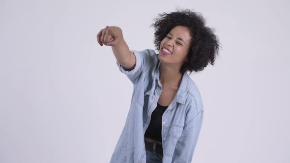 Happy Young Beautiful African Woman Laughing and Pointing Finger