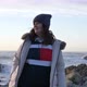 Mature Senior Caucasian Woman Looking Around Wearing Down Jacket Hat Beanie at the Sea with Slow - VideoHive Item for Sale