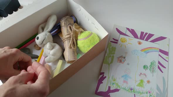 Woman Playing with a Children's Toys From a Box