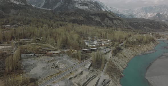 Aerial view of car driving through the forest and the lake on the side. Beautiful mountain road.Driv