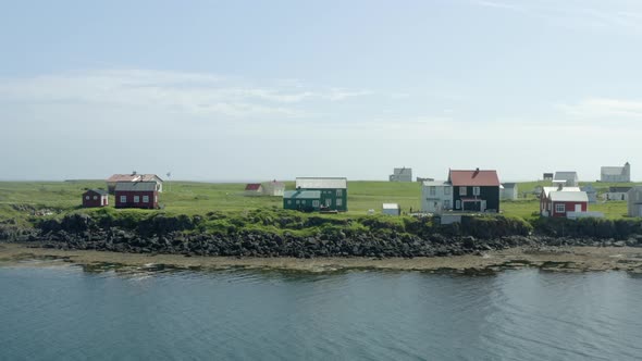 Traditional Cottages On The Coastal Town Of Flatey Island, Breidafjordur Bay In Iceland. Aerial Trac