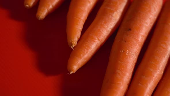 Tasty Orange Carrots on a Red Background