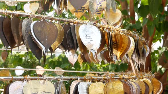 Metal Leaves with Wishes Near Temple. Rack with Traditional Metal Leaves with Wishes Located Near