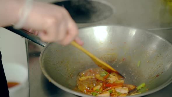 Cook Mixes Shrimps with Vegetables in a Frying Pan. Then He Separates Shrimp From Vegetables.