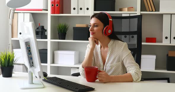 Businesswoman in White Blouse Listening Music and Looking To Monitor