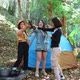 Young women cheer and drink beverage front of camping tent - VideoHive Item for Sale