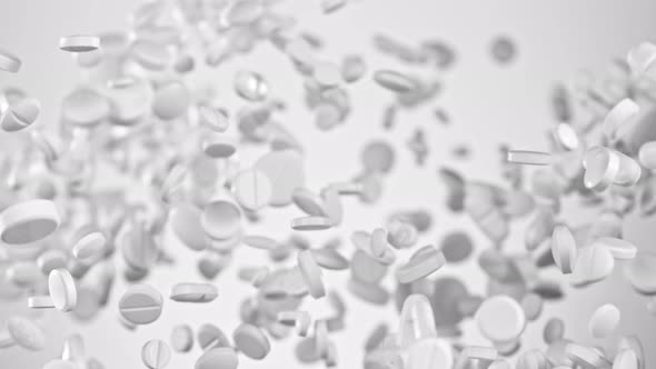 Super Slow Motion Shot of Flying White Pills on Gradient Grey Background at 1000Fps.