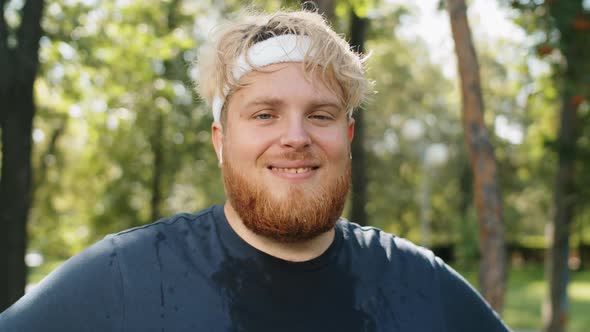 Portrait of Cheerful Overweight Man after Jogging in Park