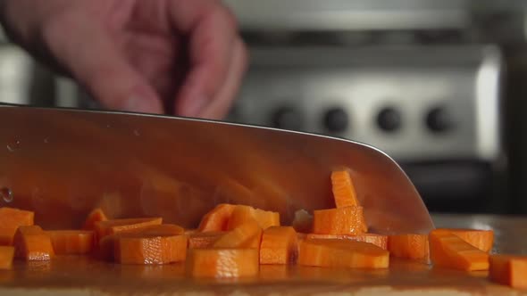 Cook Cuts A Carrot By A Knife