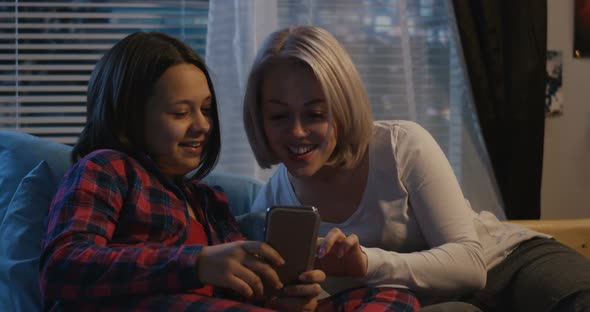 Mother and Daughter Using Smartphone