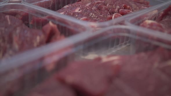 Different Cuts of Fresh Raw Beef Meat in Trays on Table in Slaughterhouse