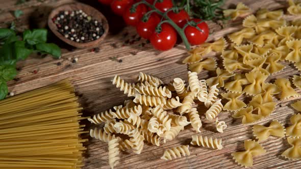Super Slow Motion Shot of Fresh Pasta Falling on Italian Decorated Wooden Table at 1000Fps