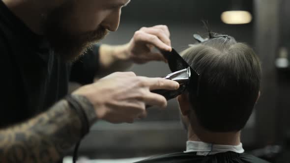 Haircut of Dark Haired Bearded Man in Barbershop