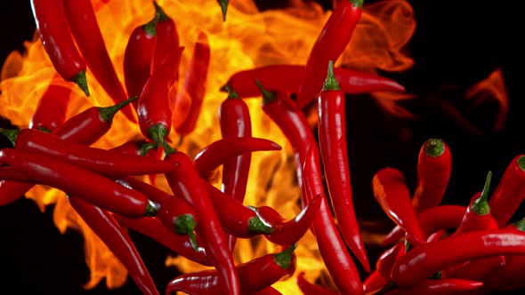 Super Slow Motion Shot of Red Chilli Peppers and Fire at 1000Fps