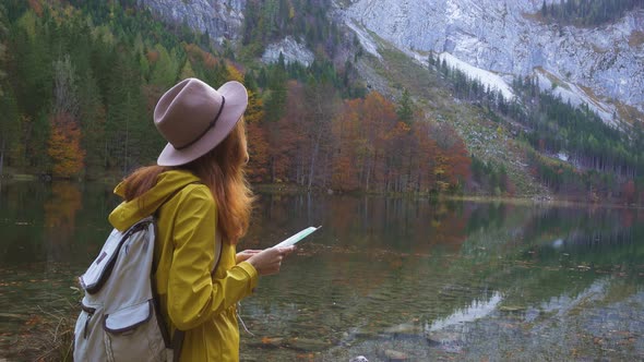 Girl With The Map At The Mountain Lake 