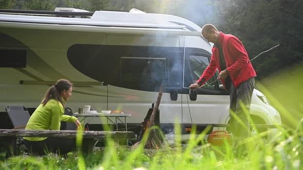 Young Couple Having Great Time on a Camping with Motorhome