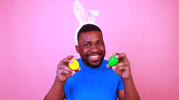 Happy Young Brazil Man with Bunny Ears in Studio Pink Wall Background