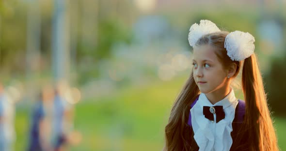 Close Up Portrait of an Elementary School Student Walking Through the Park