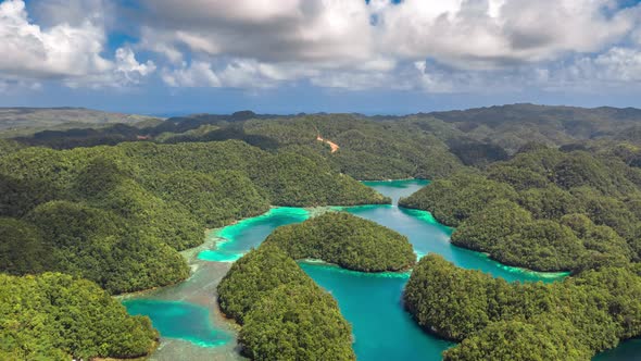 Tropical Landscape Rainforest Hills and Azure Water in Lagoon with Clouds. Сoast on the Siargao