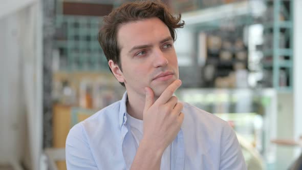 Portrait of Pensive Young Man Thinking Getting Idea