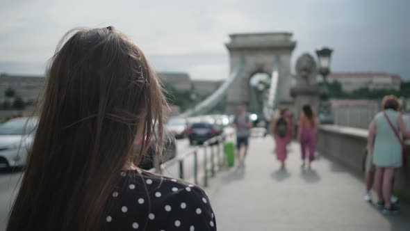 Female Tourist on Famous Szechenyi Chain Bridge in Budapest