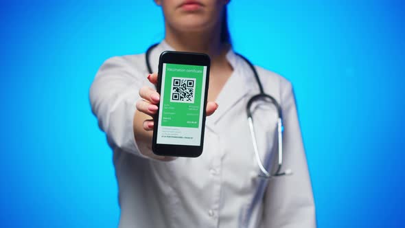 Woman Doctor in Medical Uniform Showing Vaccination Passport with Qr Code on Phone International