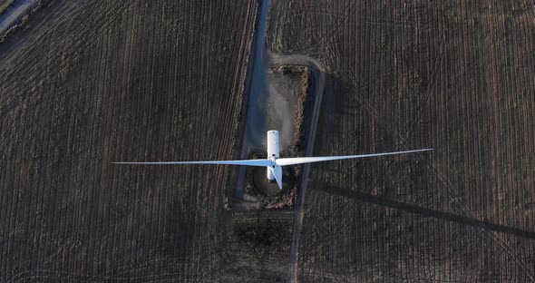 Top Down View Of Windmill On The Field - aerial drone shot