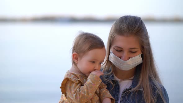 Masked Mother Holds Hand Lovely Daughter on Beach Walk During Second Wave Quarantine Coronavirus