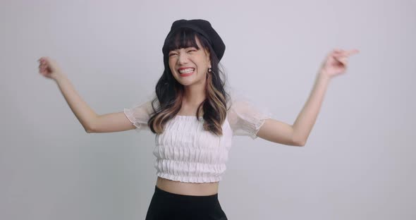 Young Lovely Asian Girl Having Fun Smiling And Dancing In Studio. People Lifestyle Concept.