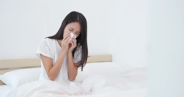 Woman sneeze on bed