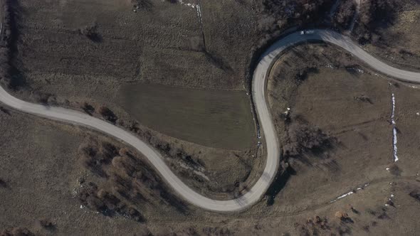 Transport vehicle on curvy road from above 4K drone video