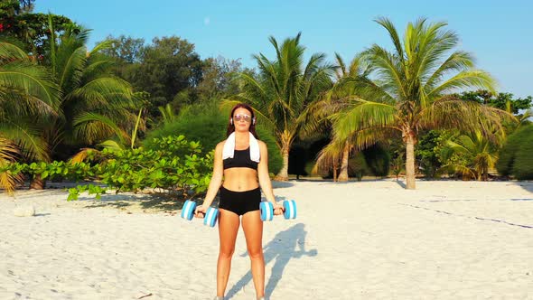 Beautiful beauty models travelling spending quality time at the beach on clean white sand and blue b