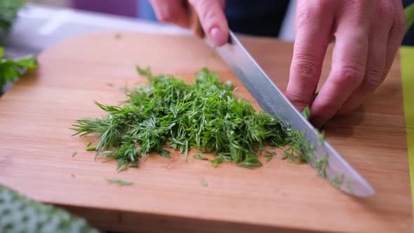 Closeup of Woman Slicing Dill on Wooden Cutting Board  Preparing Ingredient for Meal