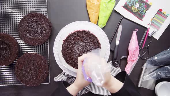 Time lapse. Step by step. Flat lay. Baker assembling a chocolate cake with bright colorful buttercre