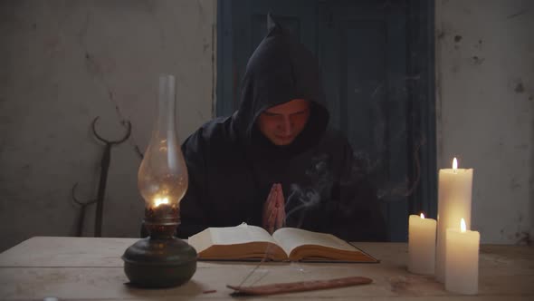 Monk with Bible Reading Prayer in Rustic House