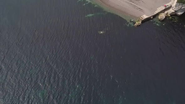 Scenic aerial view of Beer town. Gentle rising shot from ocean.