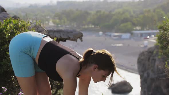 Fitness Outdoors  Young Woman Warming Up Her Body on Nature