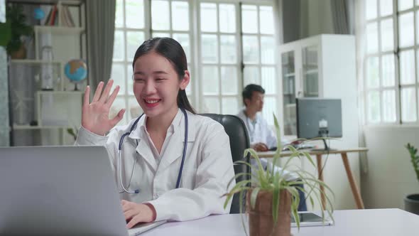 Asian Female Doctor Communicates With Patient By Video Link, Doctor Consults Patient