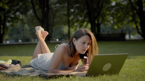 Woman watching online tv-show outdoors