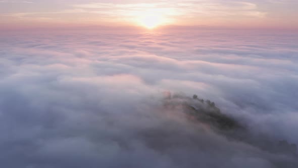 Aerial Above Pink Clouds Above Mountain Top on Magical Golden Sunrise, USA