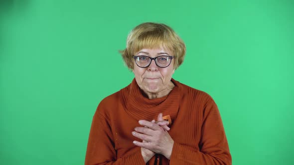 Portrait of Senior Woman Is Looking at the Camera with Excitement, Then Celebrating Her Victory