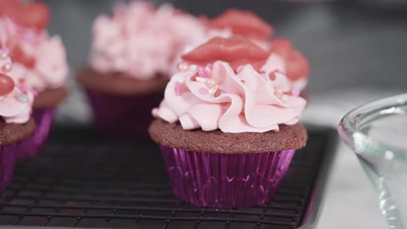 Step by step. Decorating red velvet cupcakes with chocolate red hearts and kisses.